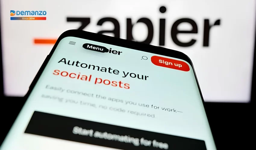 A close-up picture of the Zapier website on a smartphone showing social media automation.
